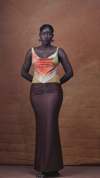 The Ifeoma Dress moving in NALÈ’s original sunset artwork print